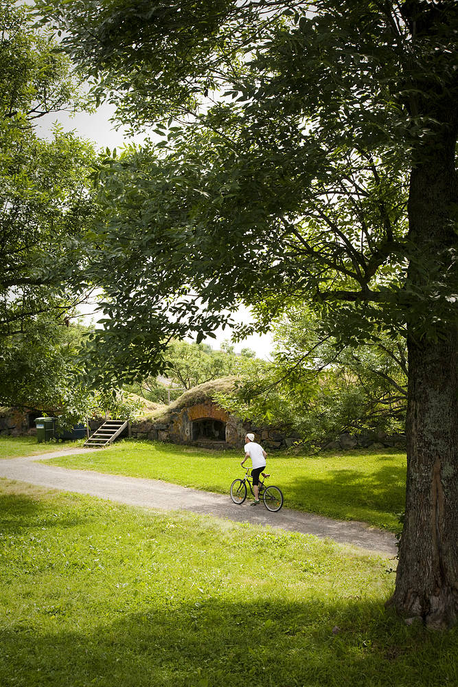 Bicycle ride through the fields with traditional Finnish houses