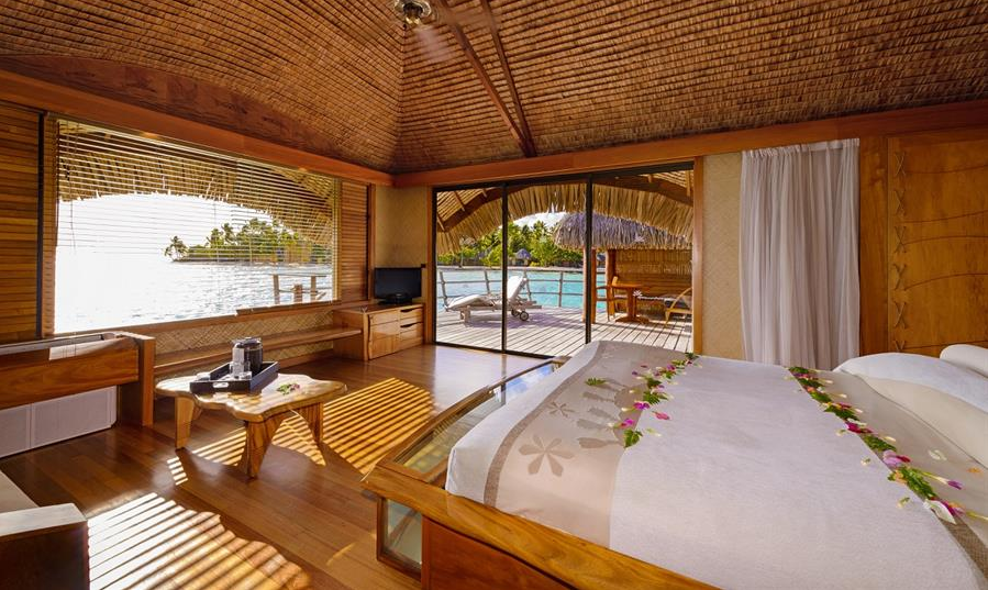 Le Taha'a Hotel luxury room in a bungalow over the water.